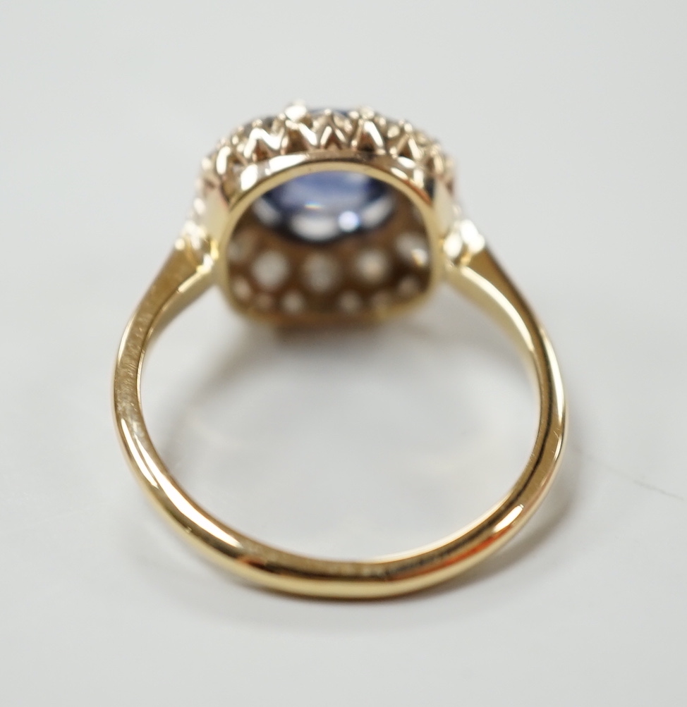 An 18ct, sapphire and diamond set cluster ring, size M, gross weight 3 grams.